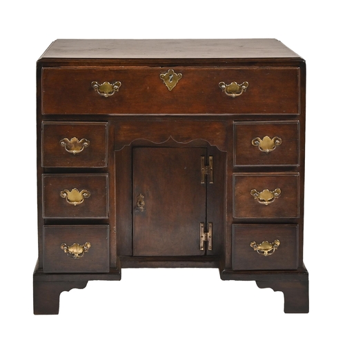 1112 - A George III oak kneehole desk, with caddy moulded top and fitted with secretaire, above apron drawe... 