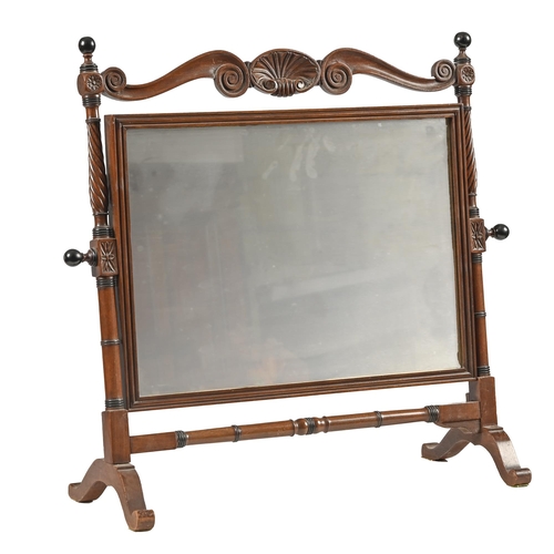 1122 - A George IV mahogany dressing mirror, the frame crested by a Venus shell flanked by scrolls, on spir... 