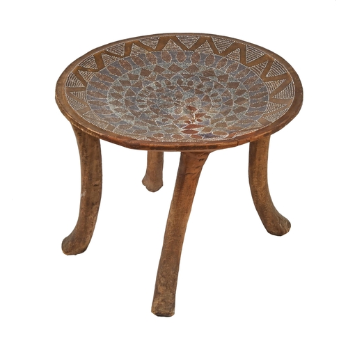 1176 - A North African dish topped stool or table, early 20th c, with beadwork decoration, on splayed legs,... 