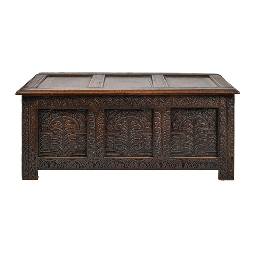 1183 - A panelled oak blanket chest, 18th c, front with carved frieze and three panels with arched top desi... 