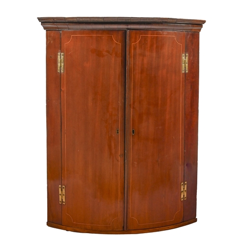 1225 - A George III bow fronted mahogany hanging corner cupboard, 97cm h; 96cm w