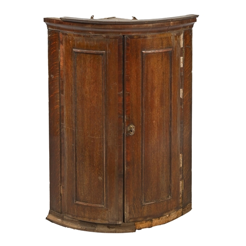 1228 - A George III bow fronted oak and crossbanded hanging corner cupboard, 99cm h; 73cm w... 