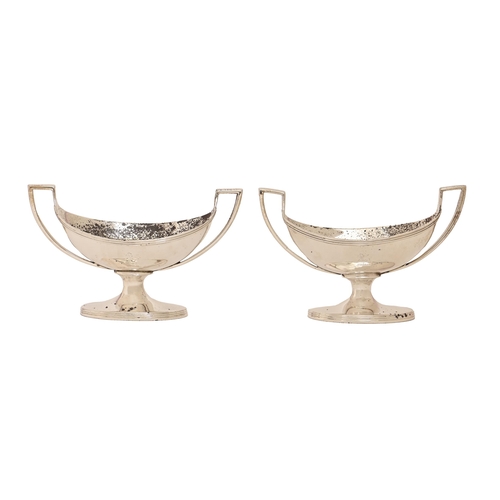 185 - A pair of George III silver salt cellars, with reeded rim and foot, crested, 13cm over handles, by J... 