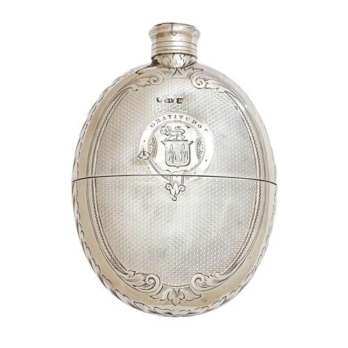 187 - A Victorian silver hip flask, engine turned with screw cap, engraved with shield of arms, crest and ... 