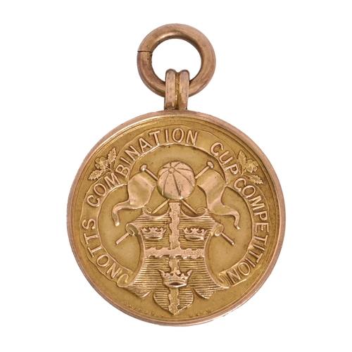 2 - Notts Combination Cup Competition. A 9ct gold football prize watch fob shield, 26mm diam, by Vaughto... 