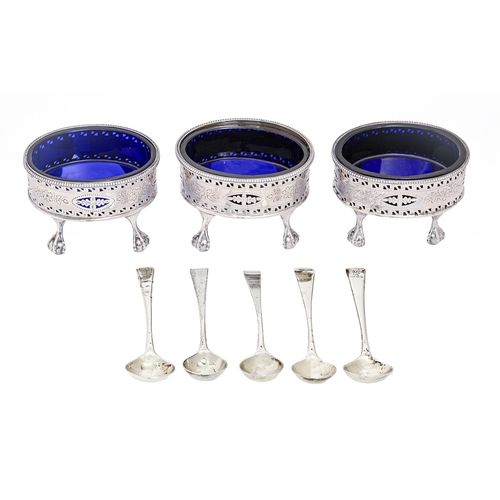 203 - A set of three George III silver salt cellars, pierced and engraved with flowers, on claw and ball f... 