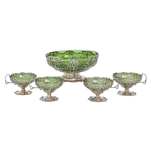 279 - A George V pierced silver sundae set, of bowl and four cups, glass liners, bowl 24cm diam, by Walker... 