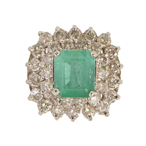 47 - An emerald and diamond ring, with approx 8.5 x 10mm step cut emerald in two tier surround of round b... 