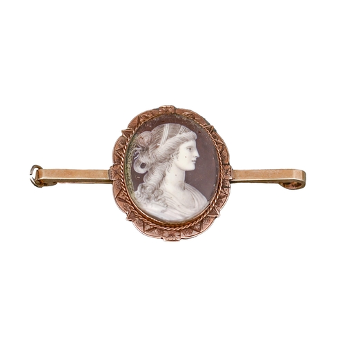 65 - A gold and enamel brooch, 19th c, painted with the head of a young woman en grisaille, mounted on la... 