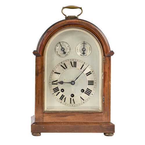 683 - A German mahogany-stained wood clock, c1900, the arched, silvered dial with chapter ring and two sub... 