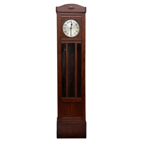 857 - An oak longcase clock, 1930s, with silvered dial, the trunk enclosed by glass door with triple bevel... 