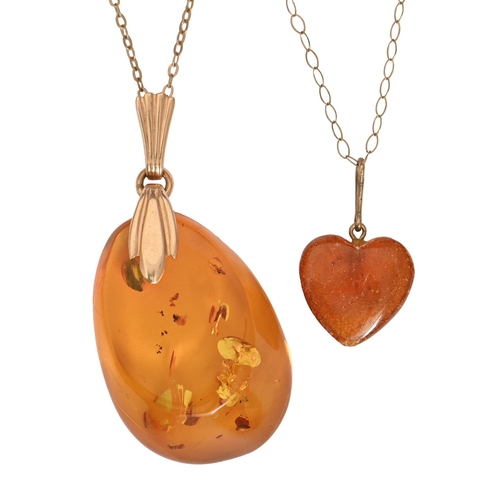 87 - An amber pendant, gold mount, marked 585, gold necklet and smaller heart shaped amber pendant on gol... 