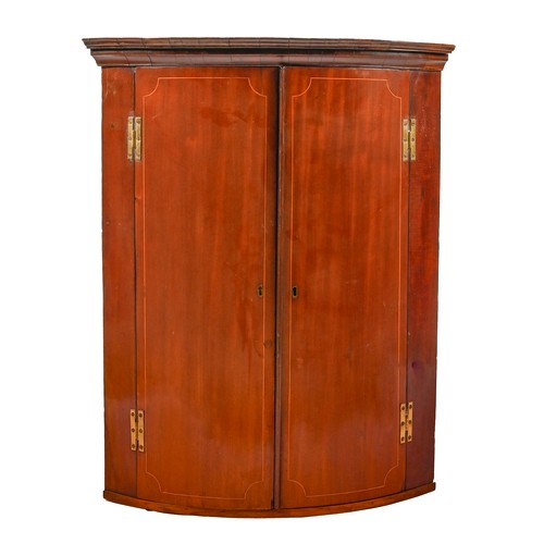 1053 - A George III bow fronted oak and crossbanded hanging corner cupboard, 99cm h; 73cm w, a George III m... 