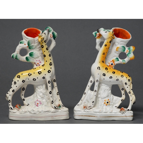 379 - A pair of Staffordshire flatback spill holder figures of giraffes or camel-leopards, c1860, 17.5cm h... 