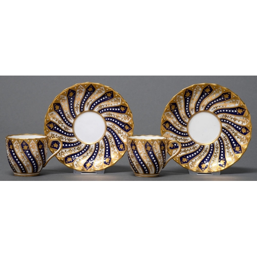 388 - A pair of Copeland bone china cups and saucers, late 19th c, spirally fluted with raised gilt decora... 