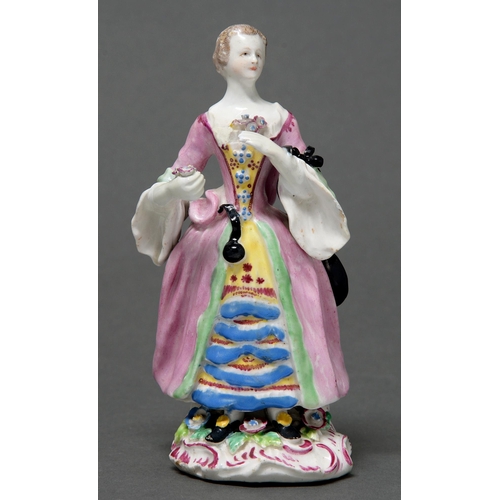 391 - A Bow figure of a courtesan, 1762, in pink open robe and holding a nosegay, on sprigged puce rococo ... 