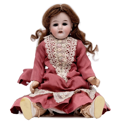 522 - A Gebruder Kuhnlenz bisque head doll, c1900, with fixed glass eyes, open mouth with upper teeth, pie... 