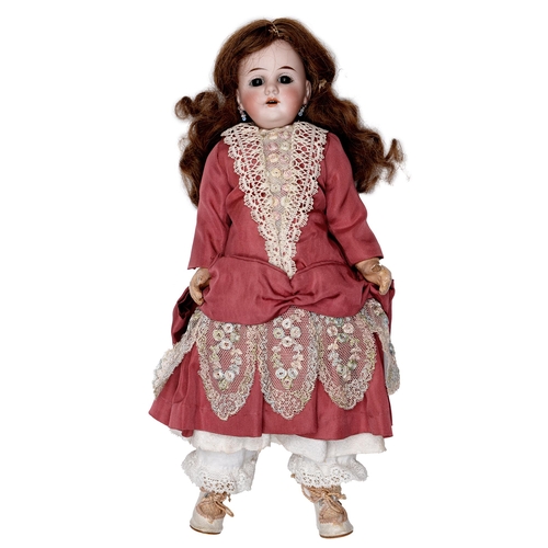 522 - A Gebruder Kuhnlenz bisque head doll, c1900, with fixed glass eyes, open mouth with upper teeth, pie... 