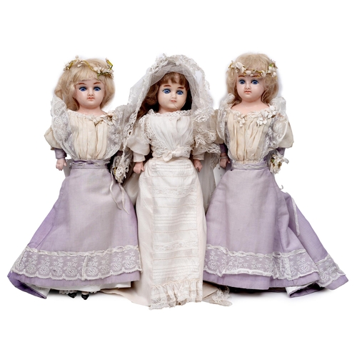 528 - A wax over composition shoulder head bride doll and two bridesmaids, c1890, with inset eyes and orig... 