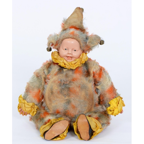 537 - A musical clown doll, c1925, with celluloid face and hands, blue and orange mohair body and yellow r... 