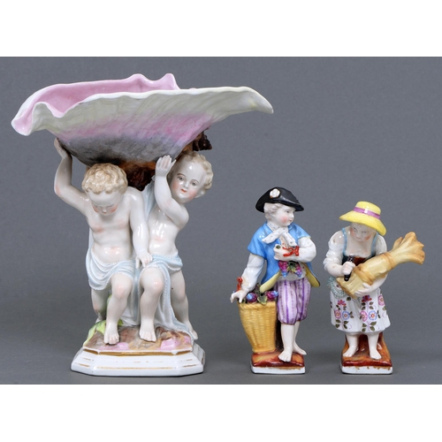 619 - A pair of Sitzendorf porcelain figures and a centrepiece, late 19th c, the girl with a wheat sheaf a... 