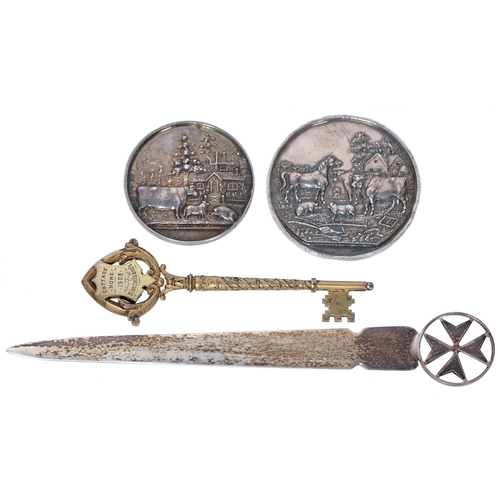 633 - A silver gilt presentation key, Birmingham 1905, 9.5cm l, two Victorian silver agricultural medals a... 