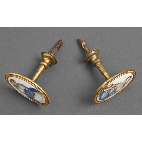 637 - A pair of George III gilt brass and enamel-inset curtain pins, printed and painted with a fashionabl... 