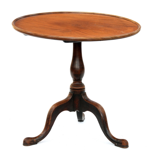 973 - A mahogany tripod table, the dished top on associated George III baluster pillar, the legs with pad ... 