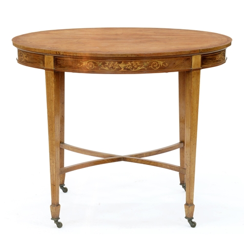 974 - An Edwardian oval inlaid mahogany centre table, on brass castors, 74cm h; 68 x 92cm