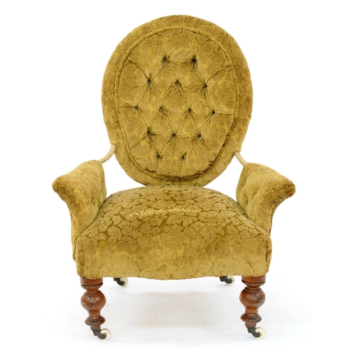 975 - A Victorian walnut armchair, with buttoned back and arms, on pottery castors