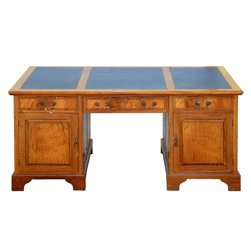 988 - A mahogany partners desk, early 20th c, with raised and fielded panels and crossbanded in rosewood a... 