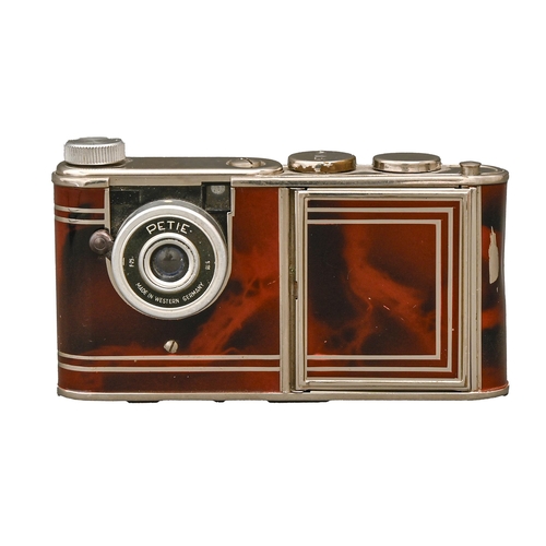 265A - A Kunik Petie Vanity subminiature camera, 1950s, in marbled red finishProvenance: Lieutenant Colonel... 