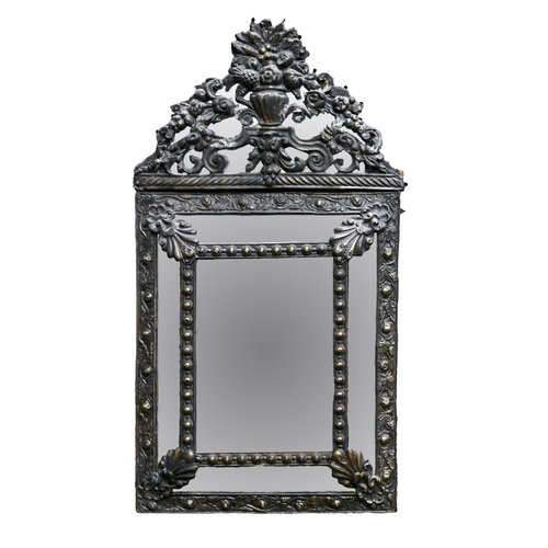 596 - A Dutch repousse brass mirror, 19th c, with central bevelled plate, the top mounted with an urn of f... 