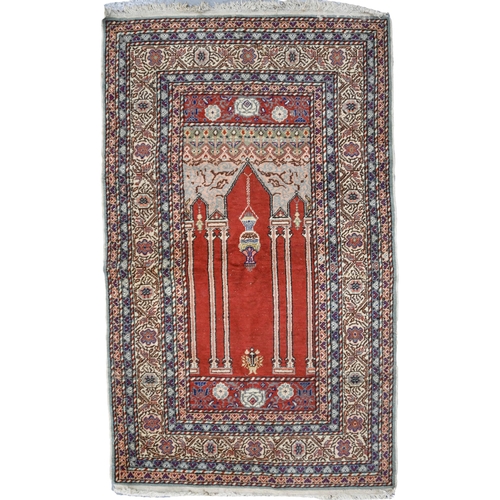 609 - Three rugs, comprising a dark brown Persian Baluch prayer rug, 87 x 136cm, a Turkish terracotta Kays... 