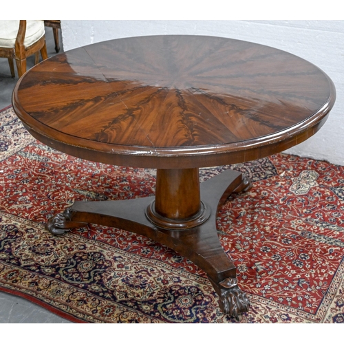 638 - A William IV mahogany breakfast table, the round top in matched flame figured radial veneers, on thr... 