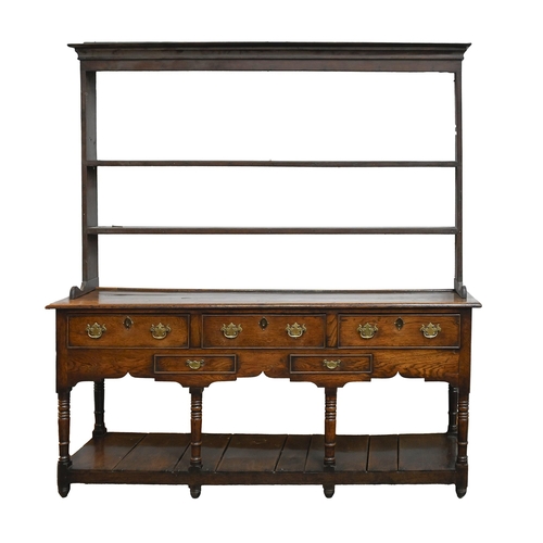 644 - A George III oak dresser, fitted with three drawers and two blind drawers to the shaped apron, on si... 