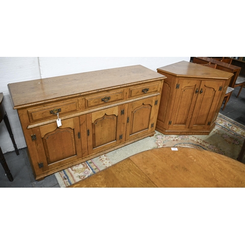 690 - An antique style panelled oak sideboard, 84cm h; 153 x 49cm, an oak extending dining table, with ped... 