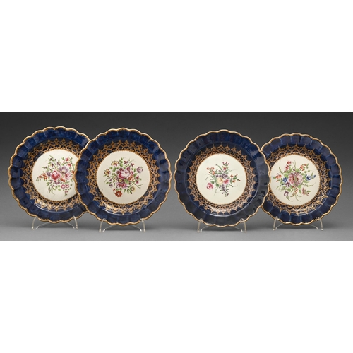 83 - A set of four Worcester plates, c1770, painted with a central bouquet reserved on a gros bleu ground... 