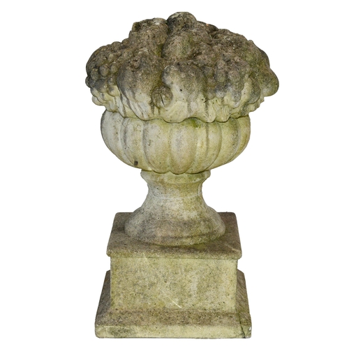 835 - A reconstituted stone finial, in the form of a vase containing fruit, 50cm h