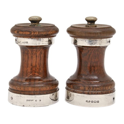 168 - A pair of George V silver mounted oak pepper mills, 90mm h, by John Grinsell & Sons, Birmingham ... 