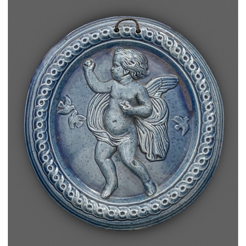 282 - A Dunmore Pottery powder blue glaze earthenware plaque, late 19th c, moulded in relief with a cherub... 