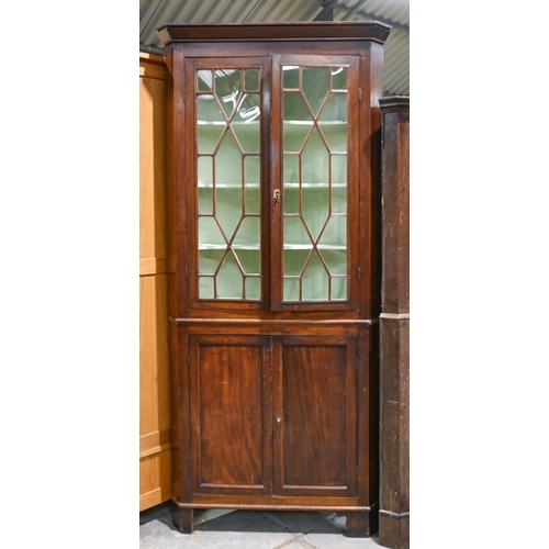 1042 - A Victorian mahogany corner cupboard, the upper part enclosed by glazed doors, on bracket feet, 214c... 