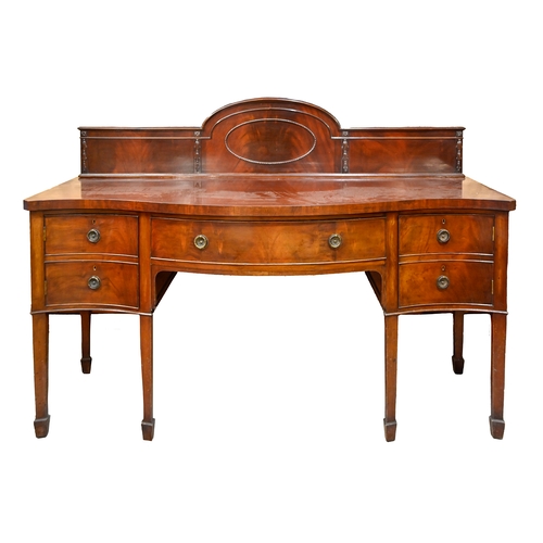 1051 - A carved and panelled oak bureau bookcase, c1930, the upper section enclosed by leaded glass doors, ... 