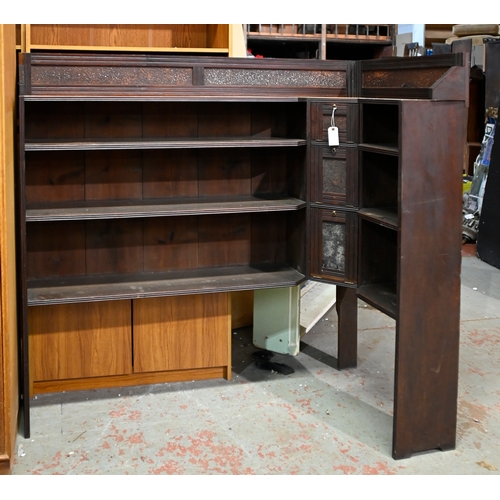 1051 - A carved and panelled oak bureau bookcase, c1930, the upper section enclosed by leaded glass doors, ... 