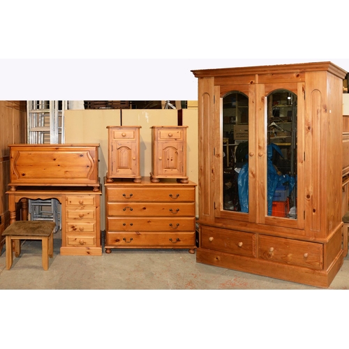 1041 - A waxed pine bedroom suite, comprising mirrored wardrobe, 195cm h; 148 x 62cm, dressing table and pa... 