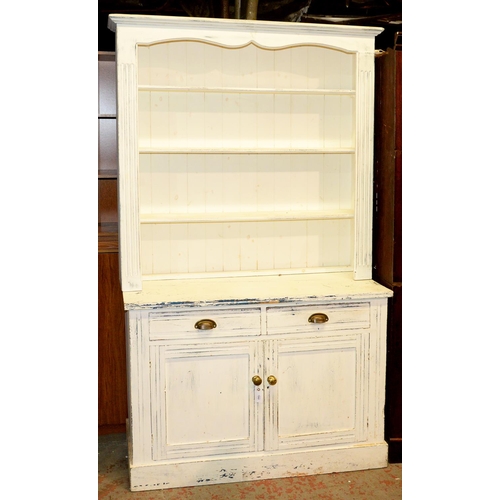 1043 - A Victorian pine dresser and rack, later painted white, the lower part enclosed by panelled doors, 2... 