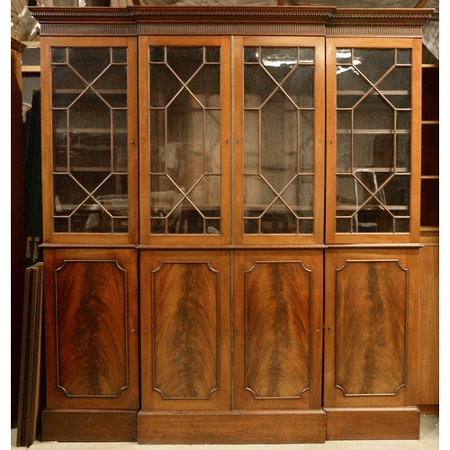 1044 - A Victorian style mahogany glazed breakfront bookcase, with Greek key cornice and adjustable shelves... 