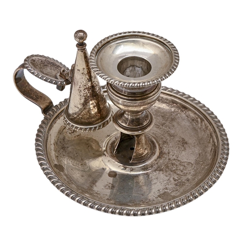 428 - A George III silver chamberstick, of plain round gadrooned form, with conical extinguisher, nozzle, ... 