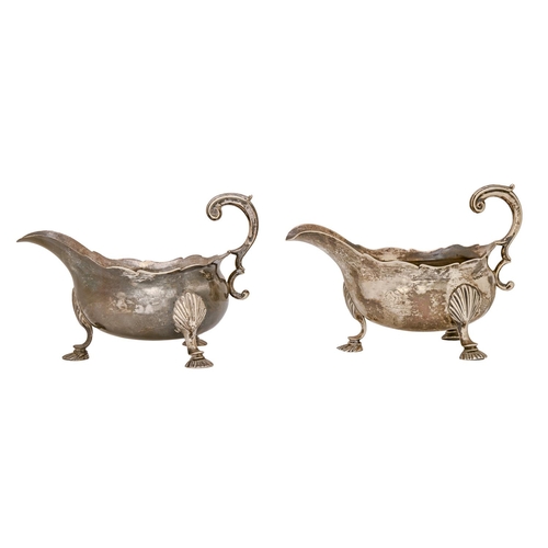 431 - A pair of George II silver sauceboats, with flying scroll handle, on hoof feet, crested, 17cm l, eng... 