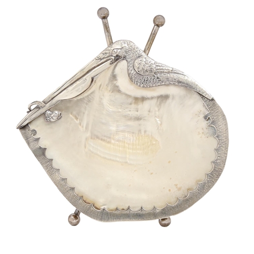 489 - A Victorian silver mounted mother-of-pearl seashell dish, the rim chased with a stork, on cylinder f... 